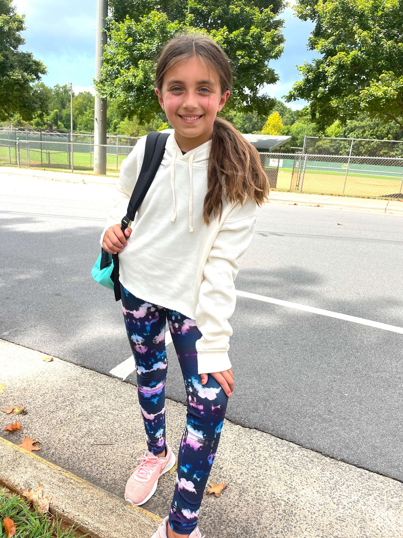 Young girl wearing a white oversized hoodie.