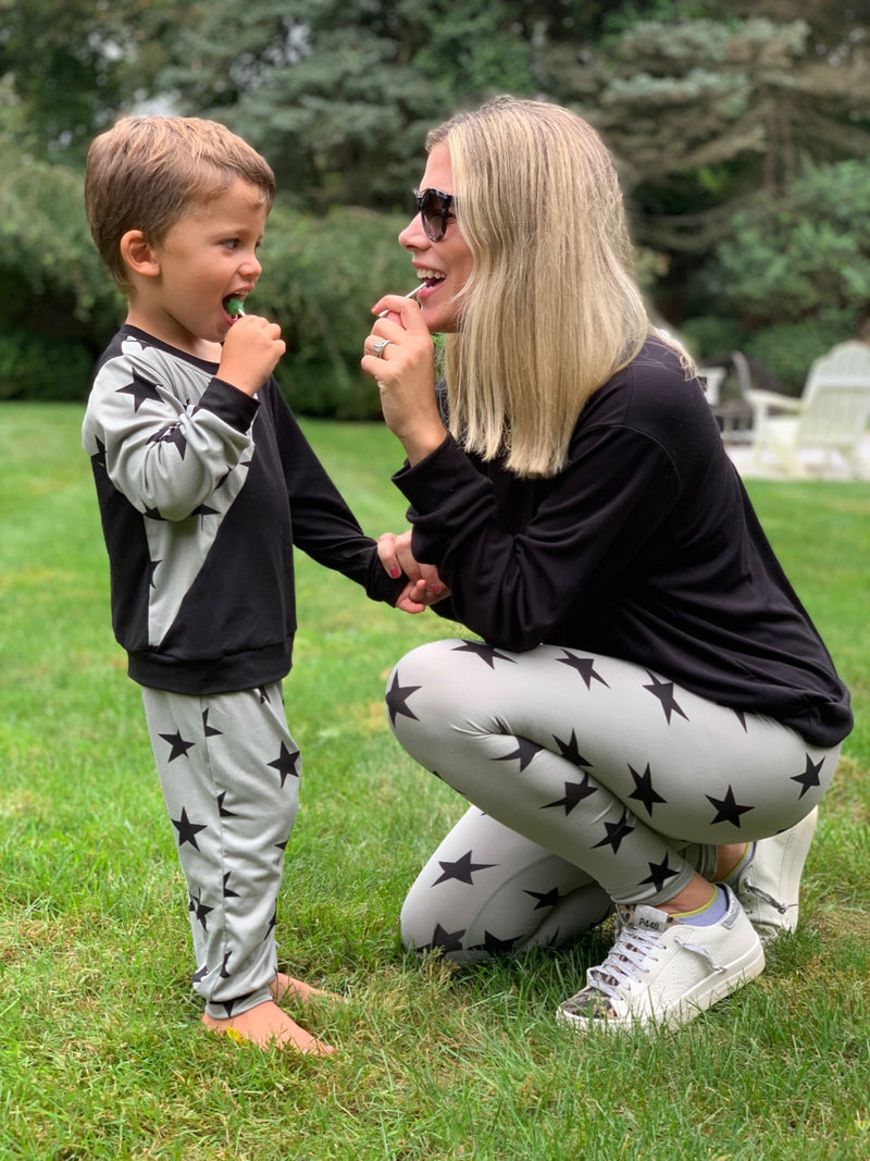 mom and son wearing matching outfit outside.